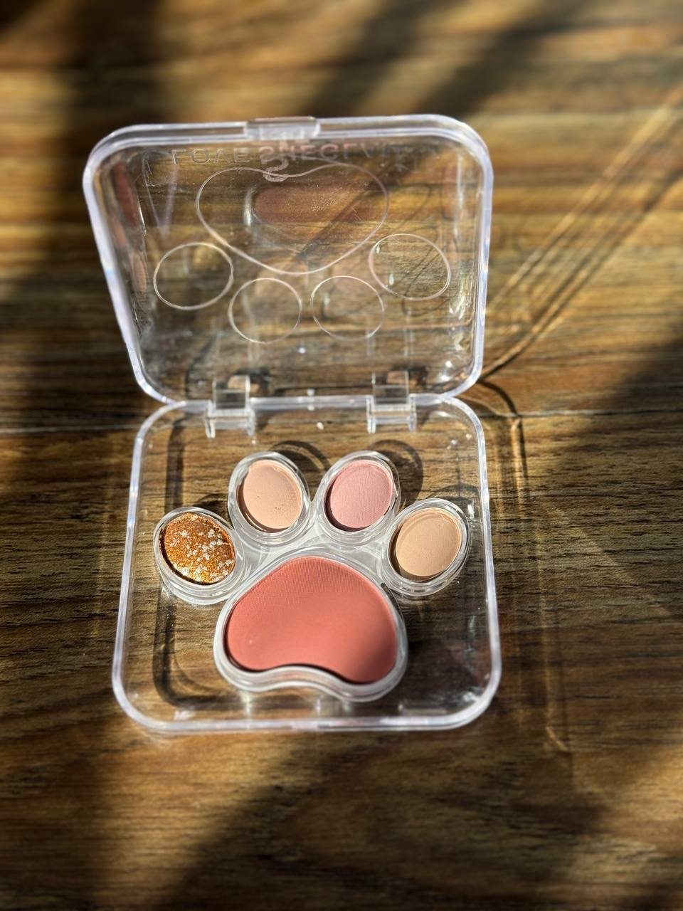 cat paw-shaped makeup product appears to be the MilleFee Meow Paws Eyeshadow Palette