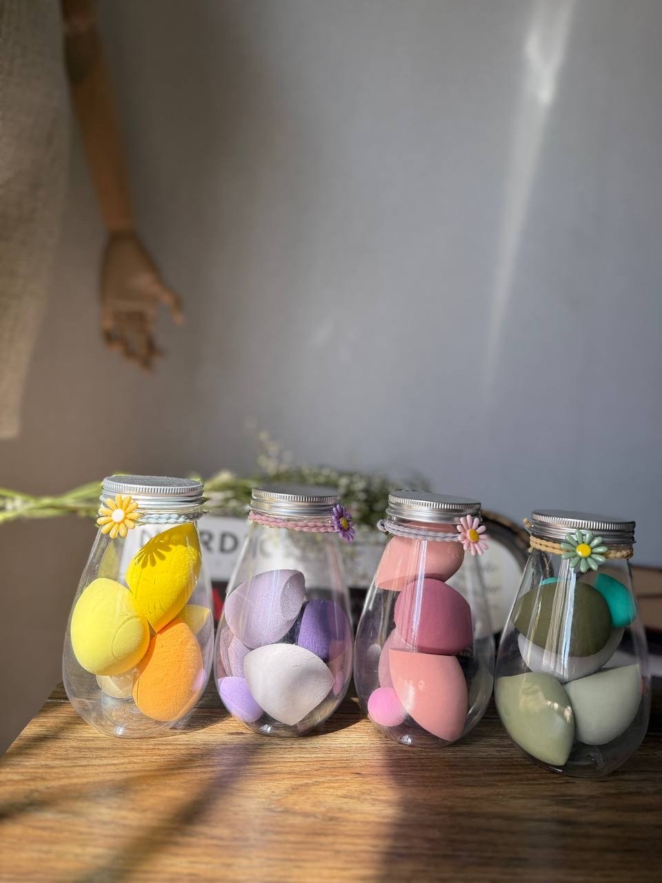 makeup sponges are stored in decorative jars